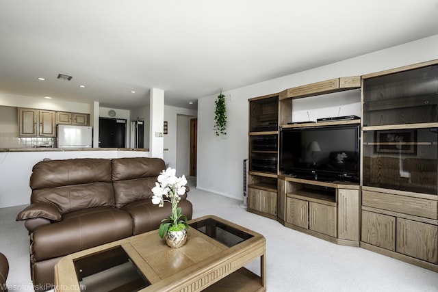 living area with light colored carpet and recessed lighting