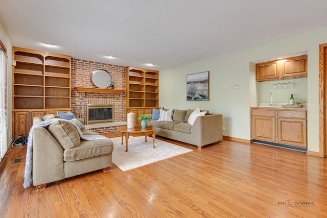 337 S Harrison Ct, Palatine, IL 60067 - living area featuring light wood finished floors, built in features, a fireplace, baseboards, and wet bar