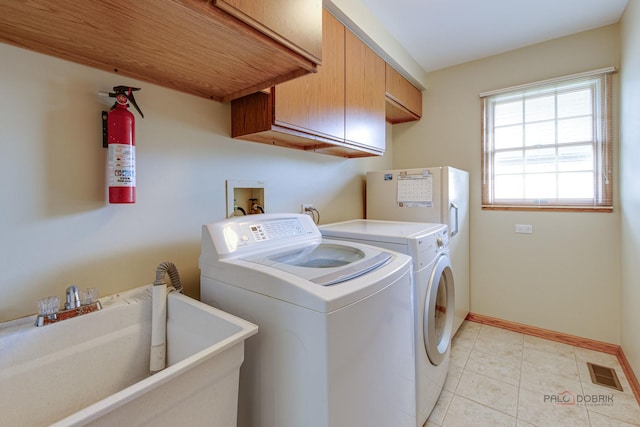 337 S Harrison Ct, Palatine, IL 60067 - laundry room with cabinet space, washing machine and clothes dryer, baseboards, and light tile patterned floors