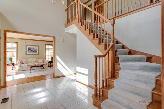 337 S Harrison Ct, Palatine, IL 60067 - stairs featuring a towering ceiling, tile patterned flooring, and baseboards