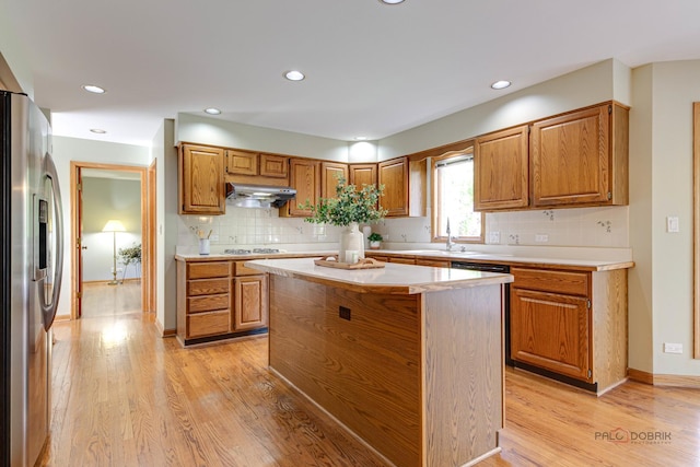 337 S Harrison Ct, Palatine, IL 60067 - kitchen featuring under cabinet range hood, stainless steel refrigerator with ice dispenser, light countertops, light wood-type flooring, and decorative backsplash
