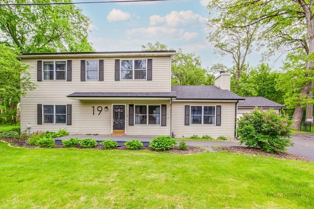 19 Eastwood Ave, Port Barrington, IL 60010 - view of front of house with a front lawn, a porch, and a chimney