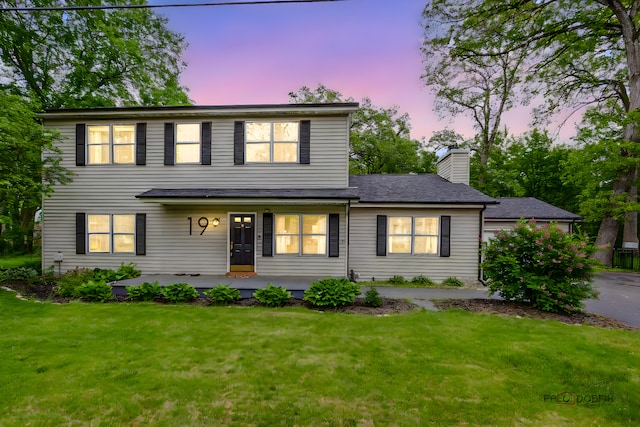 19 Eastwood Ave, Port Barrington, IL 60010 - view of front facade featuring a front yard, a chimney, and covered porch
