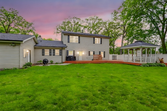 19 Eastwood Ave, Port Barrington, IL 60010 - back of property at dusk featuring a gazebo, a yard, a deck, and a chimney