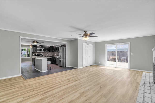 1903 Alton Dr, Champaign, IL 61821 - unfurnished living room with ceiling fan, wood finished floors, ornamental molding, baseboards, and a brick fireplace