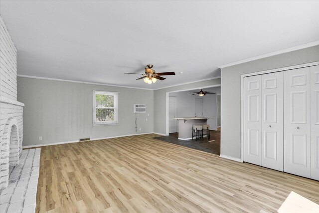 1903 Alton Dr, Champaign, IL 61821 - unfurnished living room with light wood finished floors, ceiling fan, a wall mounted air conditioner, ornamental molding, and baseboards