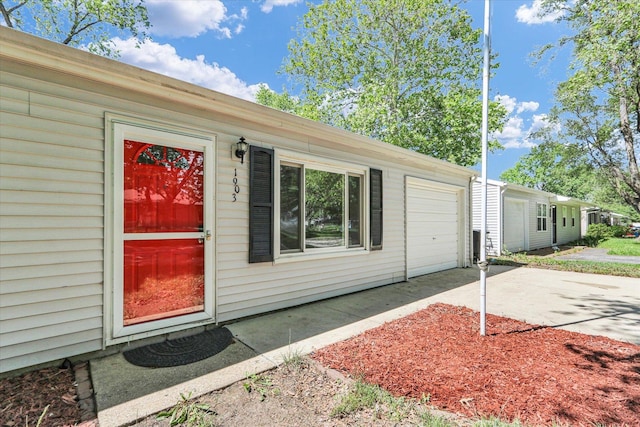 1903 Alton Dr, Champaign, IL 61821 - doorway to property with concrete driveway and a garage