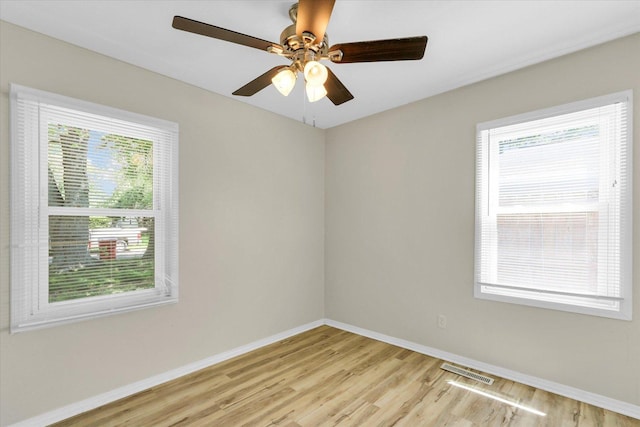 1903 Alton Dr, Champaign, IL 61821 - empty room with light wood-style floors, baseboards, healthy amount of natural light, and a ceiling fan