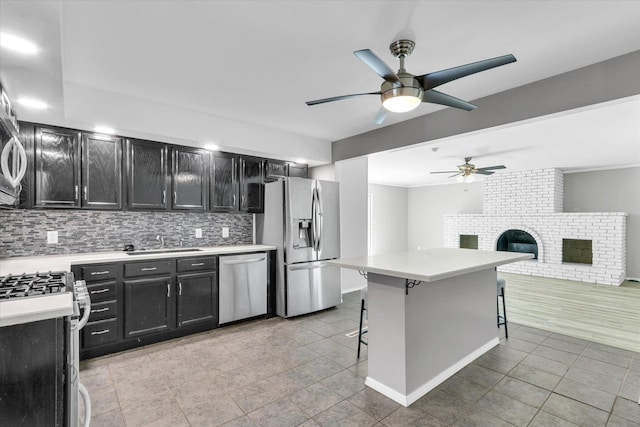 1903 Alton Dr, Champaign, IL 61821 - kitchen featuring appliances with stainless steel finishes, dark cabinetry, a ceiling fan, and a sink