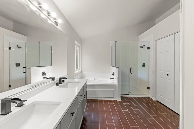 2990 Melbourne Ln, Lake In The Hills, IL 60156 - bathroom featuring a garden tub, a shower stall, double vanity, vaulted ceiling, and wood finished floors