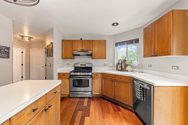 2990 Melbourne Ln, Lake In The Hills, IL 60156 - kitchen with stainless steel appliances, range hood, a sink, dark wood-style flooring, and light countertops