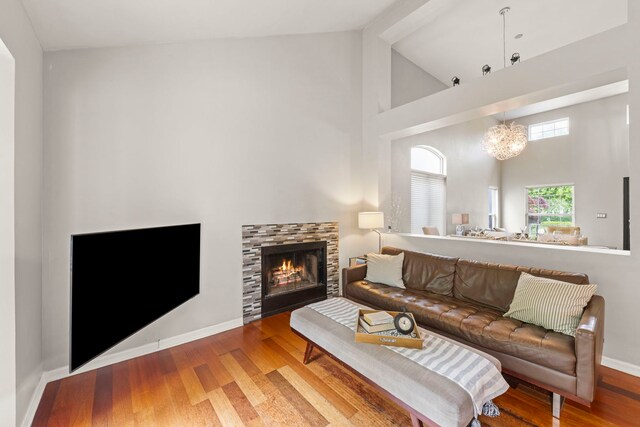 2990 Melbourne Ln, Lake In The Hills, IL 60156 - living area with high vaulted ceiling, wood finished floors, baseboards, a fireplace, and a chandelier