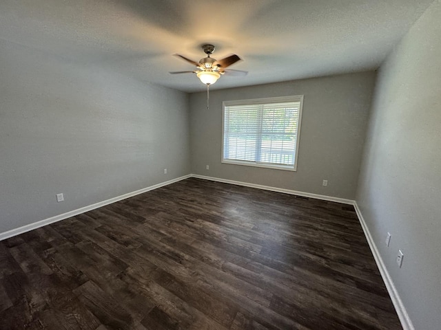 734 Keller Dr, Dixon, IL 61021 - unfurnished room with dark wood-style floors, a ceiling fan, and baseboards