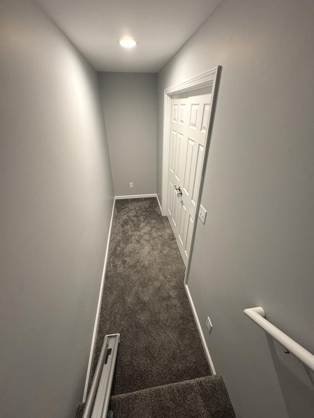 734 Keller Dr, Dixon, IL 61021 - hallway featuring dark colored carpet and baseboards