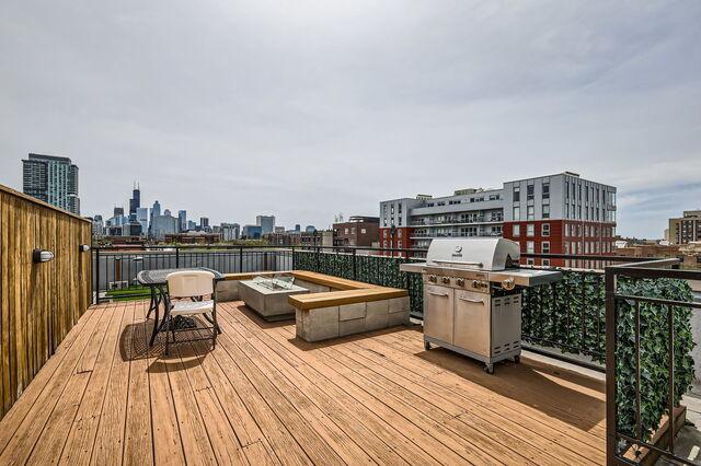 1405 N Orleans St Unit 5N, Chicago, IL 60610 - wooden deck with a skyline view, area for grilling, and an outdoor fire pit