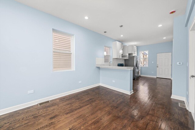 6728 S Sangamon St, Chicago, IL 60621 - kitchen featuring light countertops, a peninsula, white cabinets, dark wood finished floors, and baseboards