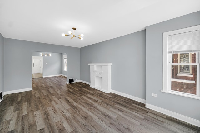 8623 S Wallace St, Chicago, IL 60620 - unfurnished living room featuring a chandelier, wood finished floors, and baseboards