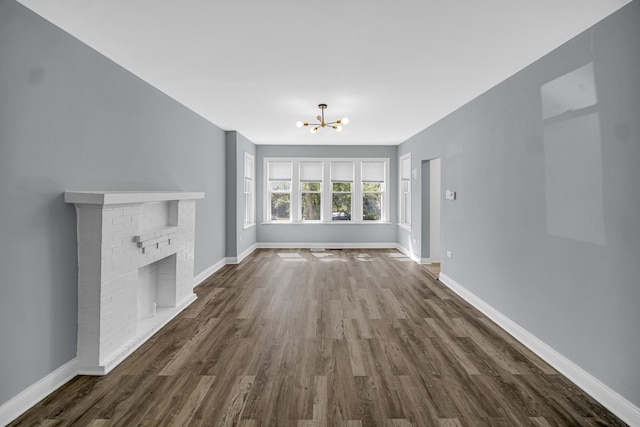 8623 S Wallace St, Chicago, IL 60620 - unfurnished living room featuring dark wood-style floors, a chandelier, and baseboards