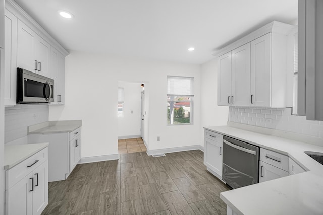 8623 S Wallace St, Chicago, IL 60620 - kitchen featuring appliances with stainless steel finishes, tasteful backsplash, light countertops, white cabinetry, and recessed lighting
