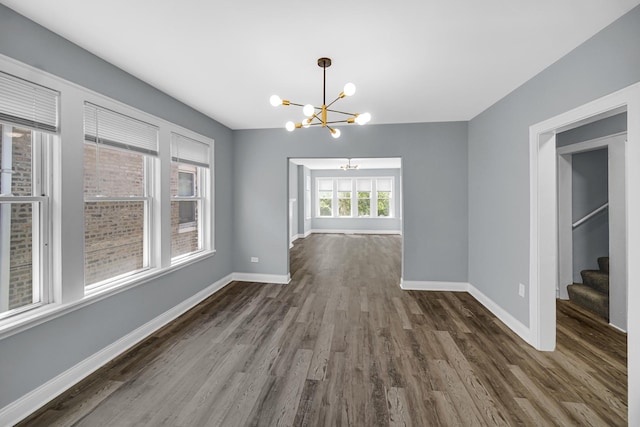8623 S Wallace St, Chicago, IL 60620 - unfurnished dining area with a chandelier, baseboards, dark wood finished floors, and stairs
