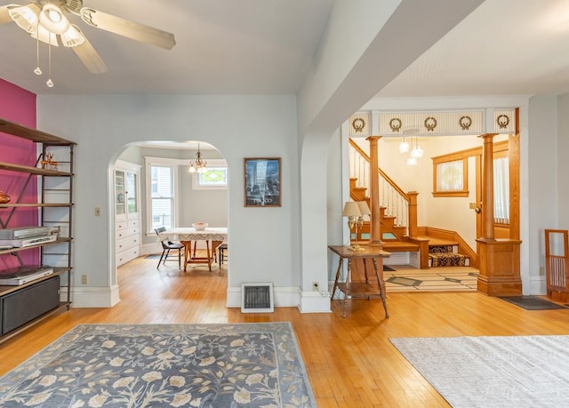 144 Hill Ave, Elgin, IL 60120 - entryway featuring arched walkways, wood-type flooring, a ceiling fan, and stairway