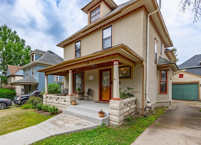 144 Hill Ave, Elgin, IL 60120 - traditional style home featuring a porch, an outbuilding, a garage, and concrete driveway
