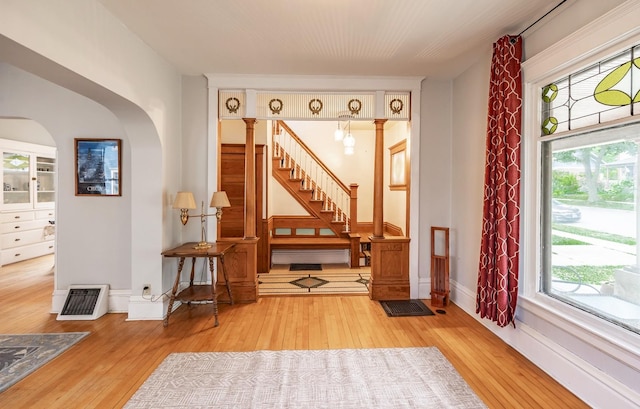 144 Hill Ave, Elgin, IL 60120 - entrance foyer featuring hardwood / wood-style flooring, healthy amount of natural light, arched walkways, and stairway
