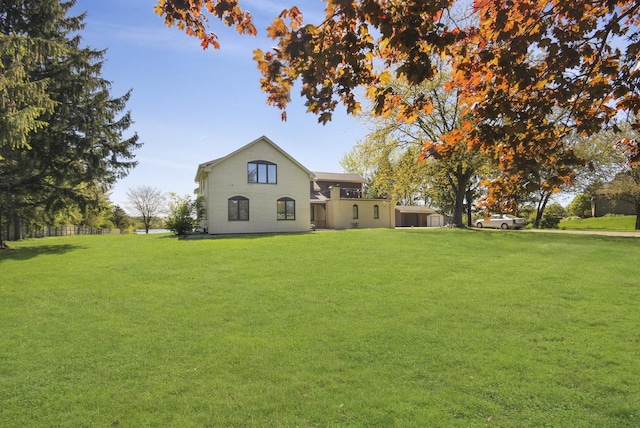 rear view of house featuring a yard