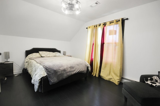 bedroom featuring lofted ceiling, a baseboard radiator, and wood finished floors