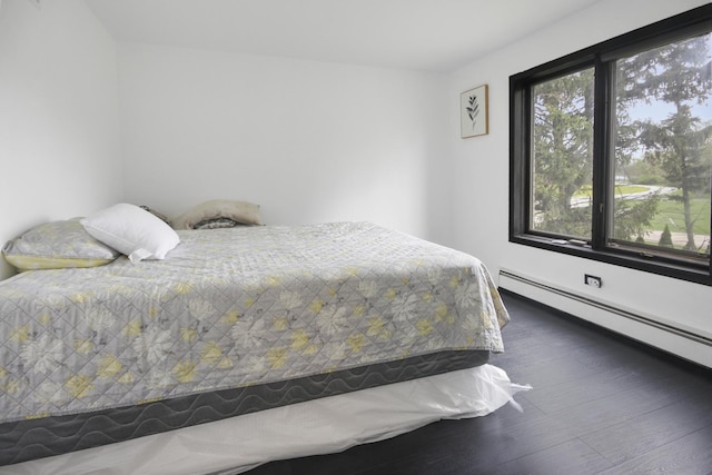 bedroom featuring a baseboard radiator and wood finished floors