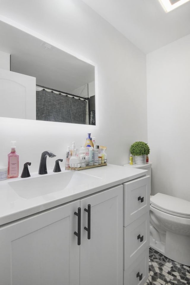 bathroom with vanity and toilet