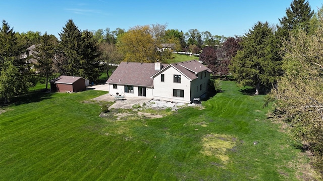 aerial view of property and surrounding area featuring a tree filled landscape