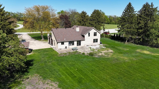 view of subject property with a tree filled landscape