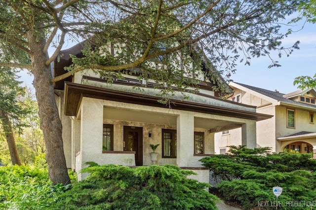 view of front of home with stucco siding and covered porch