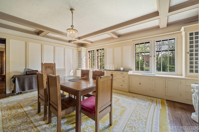 dining room featuring a decorative wall, coffered ceiling, beamed ceiling, and light wood-style floors
