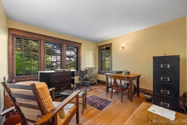 office area featuring light wood-style flooring and baseboards