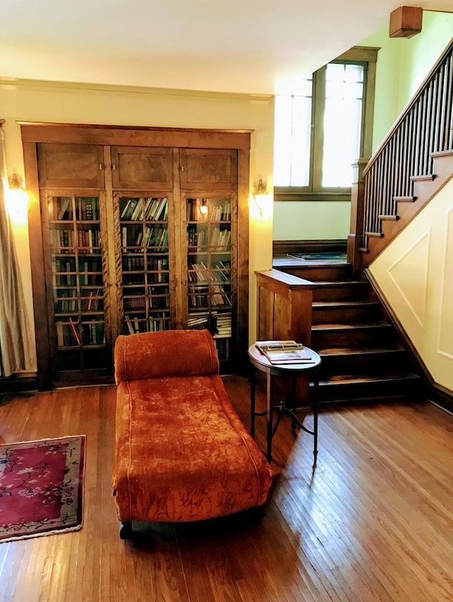 living area with wood-type flooring and stairway