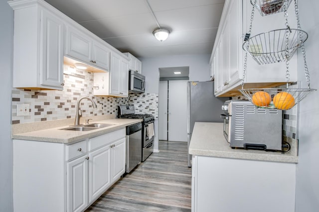 5S040 Pebblewood Ln Unit W503, Naperville, IL 60563 - kitchen featuring stainless steel appliances, a sink, light wood finished floors, and white cabinets