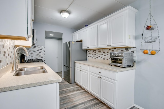 5S040 Pebblewood Ln Unit W503, Naperville, IL 60563 - kitchen with freestanding refrigerator, a sink, white cabinetry, and light countertops