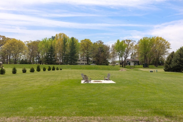 10499 E Shagbark Ln, Rochelle, IL 61068 - view of property's community featuring an outdoor fire pit, a lawn, and view of wooded area