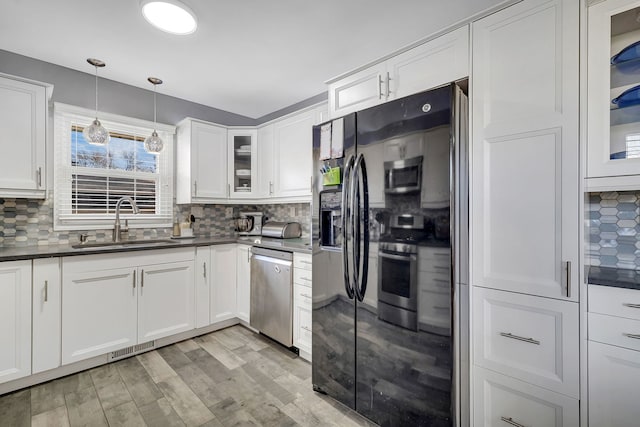 3019 Harris Dr, Joliet, IL 60431 - kitchen featuring stainless steel appliances, a sink, and dark countertops