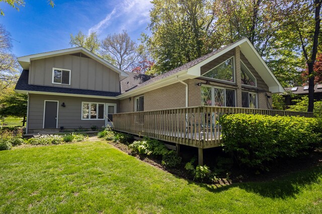 7N204 Eagle Ave, Medinah, IL 60157 - back of property with board and batten siding, a lawn, a deck, and a shingled roof