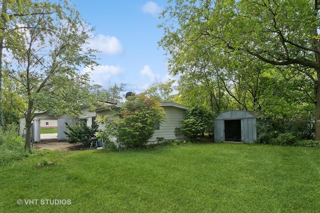 224 Shabbona Dr, Park Forest, IL 60466 - view of green lawn with a storage shed and an outdoor structure