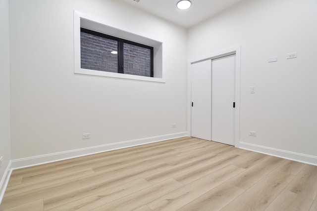1832 N Kimball Ave, Chicago, IL 60647 - unfurnished bedroom featuring wood finished floors, baseboards, and a closet