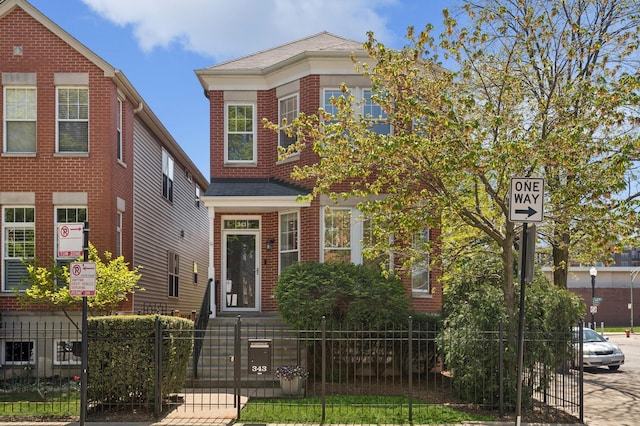 343 W Goethe St, Chicago, IL 60610 - view of front of house featuring a fenced front yard, a gate, and brick siding