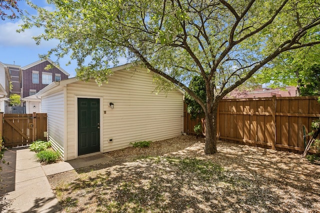 343 W Goethe St, Chicago, IL 60610 - rear view of house with fence, an outdoor structure, and a gate