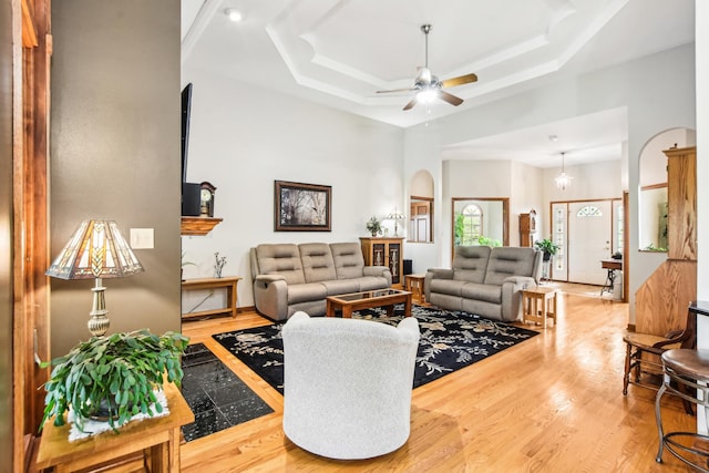 3840 W Nettle Creek Dr, Morris, IL 60450 - living area featuring a ceiling fan, wood finished floors, a towering ceiling, arched walkways, and a tray ceiling