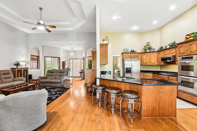 3840 W Nettle Creek Dr, Morris, IL 60450 - kitchen with appliances with stainless steel finishes, open floor plan, a breakfast bar, dark countertops, and a sink