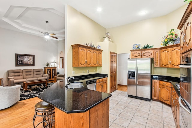 3840 W Nettle Creek Dr, Morris, IL 60450 - kitchen featuring stainless steel appliances, a sink, open floor plan, arched walkways, and a towering ceiling