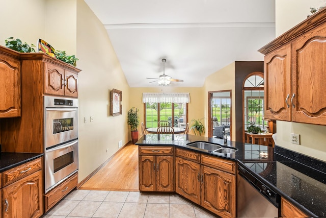 3840 W Nettle Creek Dr, Morris, IL 60450 - kitchen with appliances with stainless steel finishes, lofted ceiling, a sink, brown cabinets, and a ceiling fan